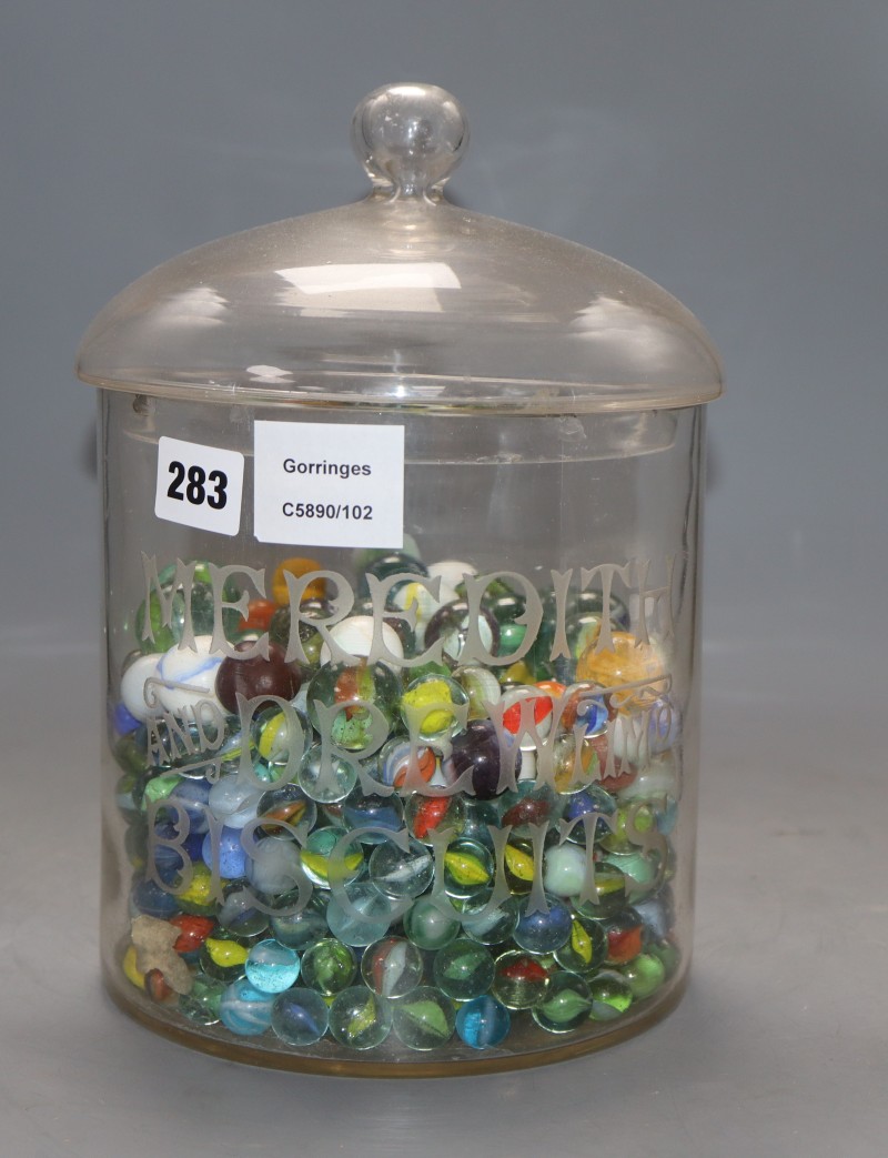 A Meredith and Drew Biscuits glass jar and cover containing Victorian and later coloured marbles, height 26cm